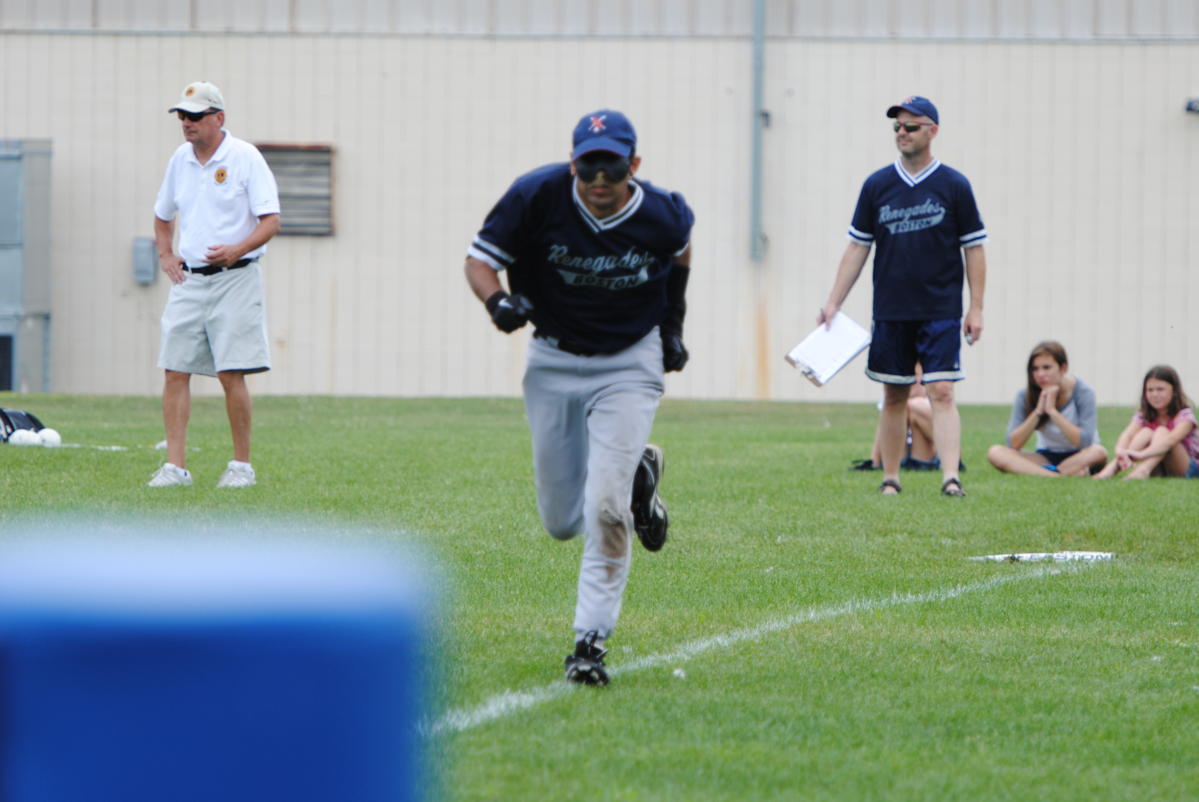 Photo of Aqil running to first base