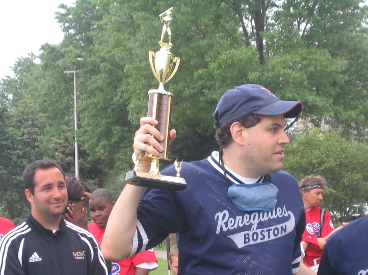 Photo of Evan holding up a trophy
