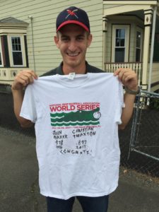 Christian Thaxton holds up a T shirt signed by John Parker