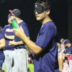 Image showing the player Shayne Cantan, owner of the highlighted quote, blindfolded and holding a bat