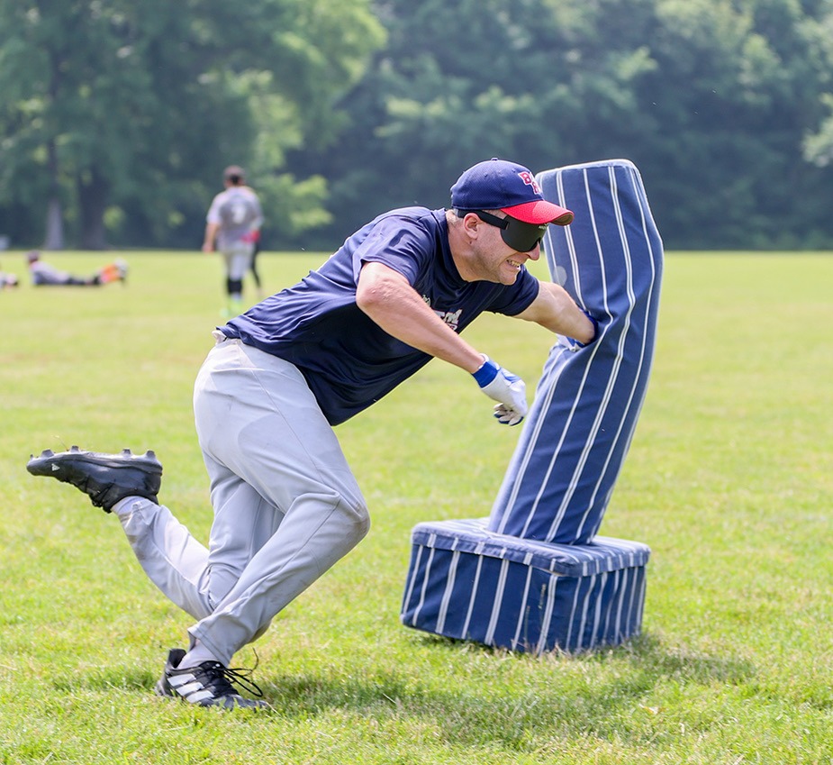 Shawn Devenish hits first base with his left hand as he begins to slide