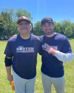 Ivan Rodriguez and Tyler Rodriguez standing next to each other with Tyler holding up the number one finger and each of them with big smiles