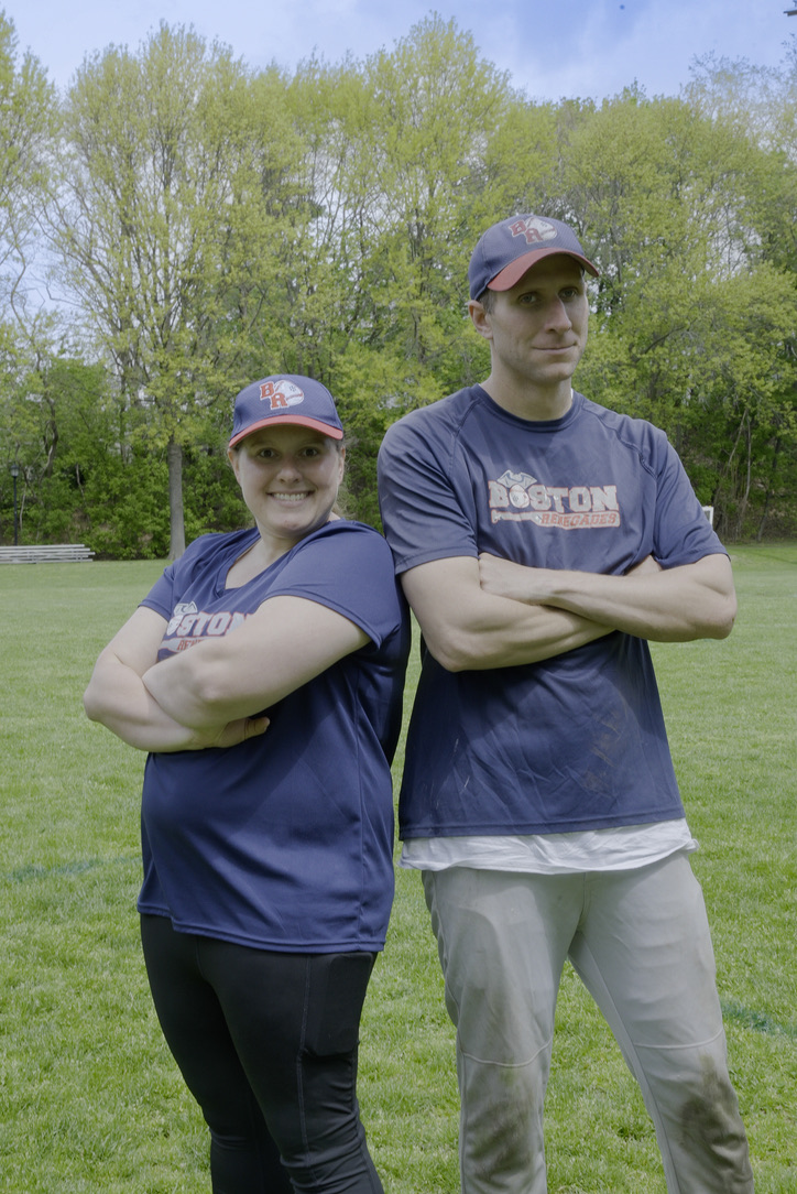 Shawn and Gina pose back to back arms crossed