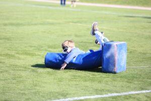 A student is lying blindfolded on the base